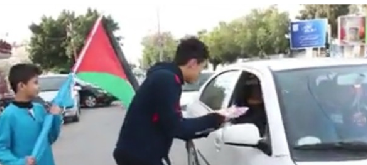 Handing out sweets with the Palestinian flag after terror attack